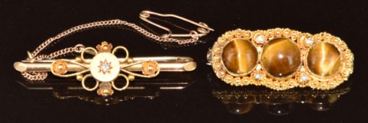 A 9ct gold brooch set with a diamond (2.5g, 3.8cm) and an 18ct gold brooch set with tiger's eye