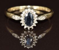 A 9ct gold ring set with an oval cut sapphire surrounded by diamonds, 2.4g, size Q