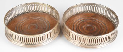 Pair of Elizabeth II hallmarked silver wine bottle coasters, London 1987, maker John Bull Ltd,