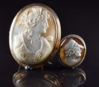 A 9ct gold brooch set with a cameo depicting a woman (5 x 6.5cm) and a yellow metal brooch set