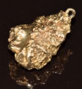 A yellow metal charm in the form of a gold nugget, 9.9g, 2.5cm