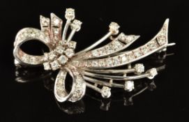 An 18ct white gold brooch in the form of a stylised bow set with diamonds, 7.5g, 3.8 x 2.2cm