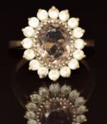 A 9ct gold ring set with a smoky quartz surrounded by spinel, 4.7g, size O