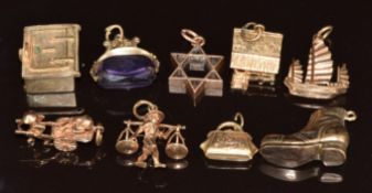 Nine 9ct gold charms including boot, swivel fob, boat, etc, 21.4g