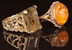 Two 9ct gold rings, one set with a smoky quartz and the other pressed amber, 12.2g, sizes O & P