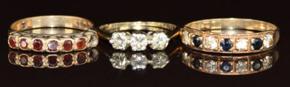 Three 9ct gold rings set with garnets, sapphires and cubic zirconia, 4.6g, sizes I, K & R