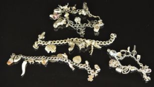 Four silver charm bracelets with over thirty five silver charms including horseshoe, car, hot air