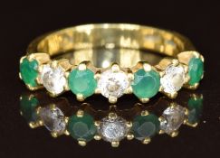 An 18ct gold ring set with cubic zirconia and synthetic green stones, 3.3g, size L