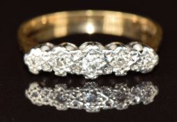 An 18ct gold ring set with five diamonds in a platinum setting, 2.4g, size M