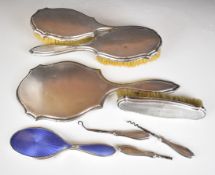 Hallmarked silver dressing table items comprising hand mirror, three brushes, button hook and two