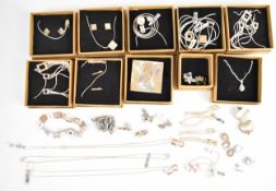 Five suites of silver jewellery comprising necklace and earrings set with diamonds, five silver