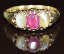 A 9ct gold ring set with an oval cut ruby and two chrysoberyl cabochons, 4g, size O