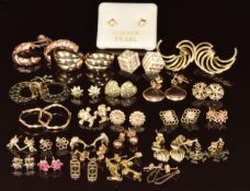 Twenty six pairs of 9ct gold earrings including hoops, tri-coloured, ruby cluster, hearts,