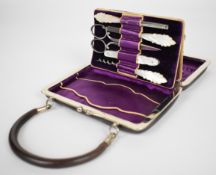 Vintage novelty necessaire in the form of a leather handbag, the contents with carved mother of