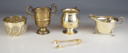 Hallmarked silver items comprising Victorian embossed sugar bowl and nips to suit, twin handled