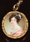 Victorian yellow metal locket set with an ivory portrait miniature depicting a young woman, verso