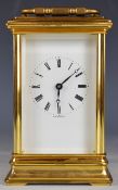 St. James, London gilt metal cased carriage clock with bevelled glass and white enamel dial marked