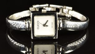 Gucci ladies wristwatch with steel hands, white dial, square stainless steel case and quartz
