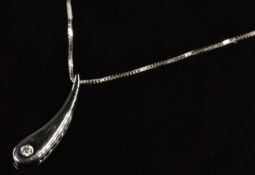 An 18ct white gold pendant set with a diamond, on 18ct white gold chain, 2.8g, 40cm
