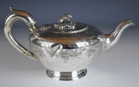 Victorian hallmarked silver teapot of bulbous form with engraved decoration and floral final or