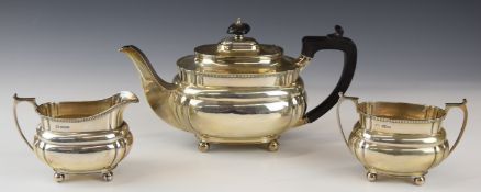 George V hallmarked silver three piece tea set of lobed form, raised on four ball feet, Sheffield