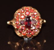 A 9ct gold ring set with garnets in a cluster, 4.9g, size M