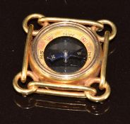 An 18ct gold compass charm, 7.1g, 1.8cm