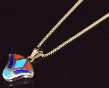 An 18ct gold pendant set with turquoise, lapis lazuli and coral (2.1cm) on 18ct gold chain, 6.5g,