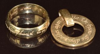 A 9ct gold ring by Fusion with engraved script (6.7g, size U) and a St Justin pendant