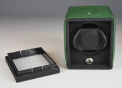 Rapport of London automatic wristwatch winder with green leather exterior and glass front, 12x11.