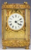 Gilt metal cased carriage clock with bevelled glass and white enamel and gilt fretwork dial,