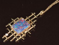 A 1970's 9ct gold pendant set with a black opal triplet and a diamond (5cm) on 9ct gold chain, 7.1g,