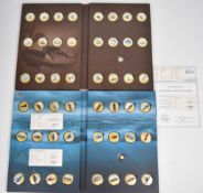Famous Ships of the World coin set comprising two presentation folders, each containing one 0.5g .