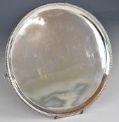 Georgian hallmarked silver card tray or salver with beaded edge, raised on three feet, London