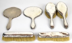 Hallmarked silver mounted dressing table items comprising two hand mirrors and four brushes,