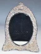 Elizabeth II hallmarked silver framed dressing table mirror with embossed decoration, bevelled