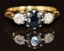 An 18ct gold ring set with a sapphire and two diamonds, 3.4g, size N