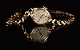 Regency 9ct gold ladies wristwatch with gold hands, Arabic numerals and baton hour markers, silver