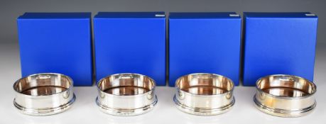 Set of four Elizabeth II Britannia standard hallmarked silver wine bottle coasters, Sheffield