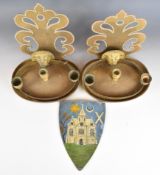 19thC metalware comprising two brass wall candle sconces with Arts & Crafts style decoration and