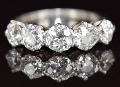 A platinum ring set with five old cut diamonds of approximately 0.65ct, 0.55ct, 0.55ct, 0.4ct and