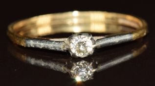 An 18ct gold ring set with a diamond in a platinum setting, 1.7g, size T