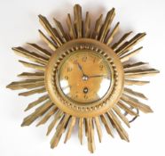 19th or early 20th century gilt starburst wall clock with single train movement, overall diameter