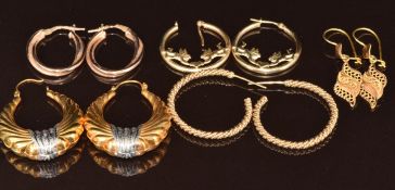 Two pairs of 9ct gold hoop earrings (6.2g), two pairs of yellow metal earrings (6.3g) and a pair