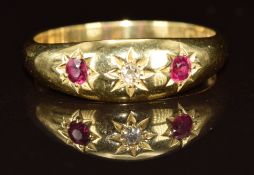 An 18ct gold ring set with a diamond and two rubies in star settings, Chester 1911, size Q