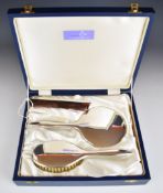 Elizabeth II cased hallmarked silver dressing table set comprising hand mirror, brush and comb,