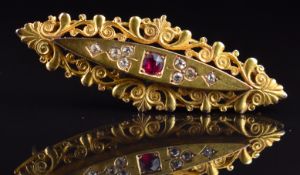 A 9ct gold c1900 brooch set with a ruby and old cut diamonds, 6.8g, 4.5cm
