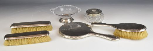 Hallmarked silver dressing table set comprising hand mirror and three brushes, together with a