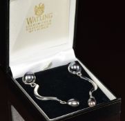 A pair of silver earrings set with pearls by John Watling