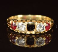 An 18ct gold ring set with rubies and diamonds, each diamond approximately 0.15ct (centre ruby